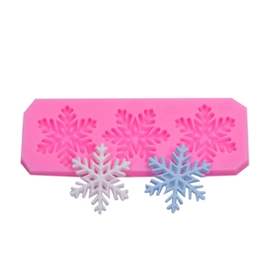 Macro detail of pink silicone mold with 3-hole snowflake shapes for DIY cake decorating