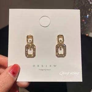Elegant gold geometric square dangle earrings with sparkling cubic zirconia crystals