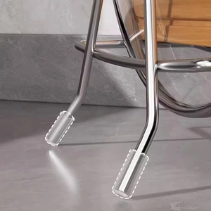 Transparent silicone chair leg protectors for round metal legs on modern grey flooring
