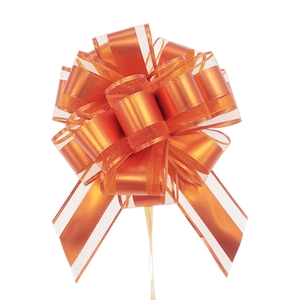 Close-up of bright orange matte pull bow with organza ribbons for gift wrapping