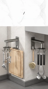 Close-up of 360 rotating kitchen wall hook holding spatulas and cutting boards