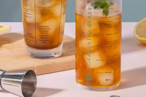 Detail of a graduated cocktail glass with precise milliliter and ounce measurement scales