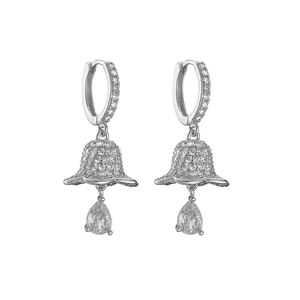 Detailed view of silver drop earrings with white zircon accents and a pear-cut stone