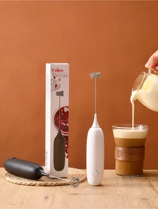 Detail of handheld electric milk frothers in black and white with packaging box