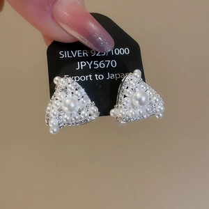 Detailed view of silver triangle stud earrings with faux pearls and micro-pave crystals