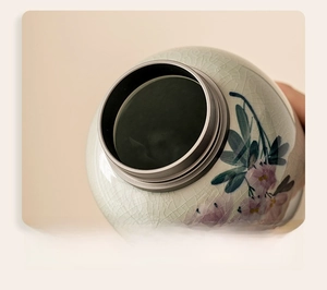 Close-up of 5.2cm wide round opening on hand-painted ice-crackle glaze ceramic tea canister
