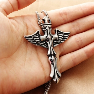 Punk style silver stainless steel cross wing pendant necklace shown in hand