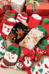 Close-up of thick coral fleece Christmas socks with festive elk and Santa patterns