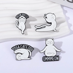 Cute set of white yoga cat enamel pins with creative Meowmaste lettering on white stand