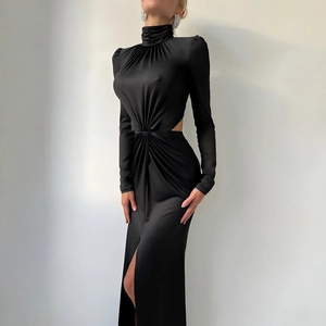Detail of waist cut-out and ruching on a black satin long-sleeve maxi dress