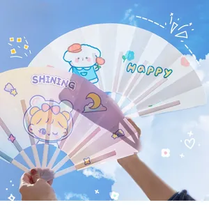 Outdoor shot of cute cartoon folding fans with girl and dog illustrations under blue sky