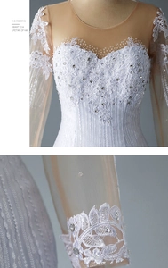 Detail of bridal dress with lace floral embroidery, sequins and sheer mesh sleeves