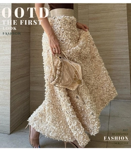 Detail of 3D petal texture on high-waisted beige maxi skirt for evening wear