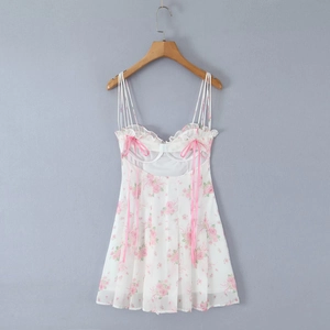 Detail of white chiffon mini dress with pink floral print and delicate bow straps