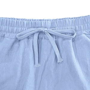 Macro detail of breathable linen fabric texture and elastic drawstring waistband in light blue