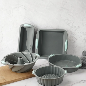 5-piece heat resistant grey silicone baking set with blue handles on marble counter