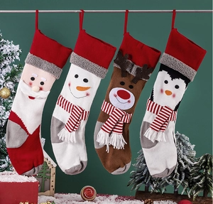 Detail of knitted Christmas stockings featuring Santa, Snowman, Reindeer and Penguin motifs