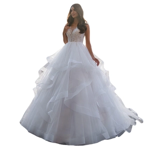 Elegant white lace ball gown wedding dress with deep V-neck and layered tulle skirt
