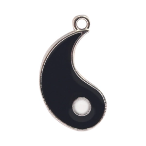 Close-up of Yin Yang Tai Chi alloy pendant with black enamel fill and silver metal edges