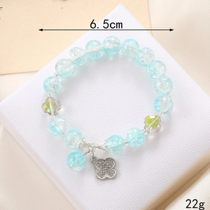 Detail of light blue beaded bracelet with green floral beads and clover charm