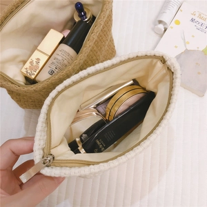 Close-up of woven canvas texture and zipper detail on two-tone cosmetic bags