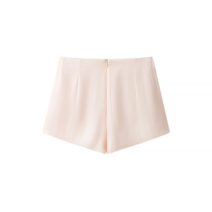 Detail of high-waist light pink shorts with pleated texture and back zipper closure