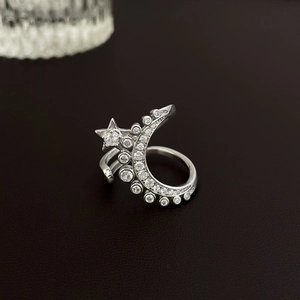 Detailed macro view of silver open ring featuring zircon encrusted star and moon motifs