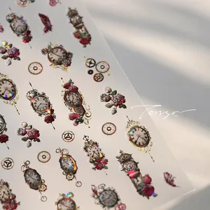 Macro detail of holographic vintage clock and rose nail art stickers with laser finish