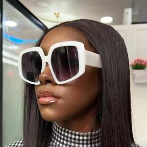 Modern oversized white square sunglasses with dark gradient lenses on a model