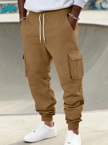 Detail of khaki cargo joggers with adjustable drawstring waist and large side pockets