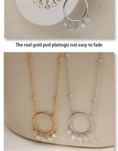 Detail of PVD gold plated dreamcatcher pendant with sparkling cubic zirconia charms