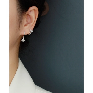 Detail of silver S925 sterling silver hoop earrings with star pendant and zircon stones
