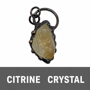 Close-up of raw natural citrine crystal pendant with vintage bronze metal setting