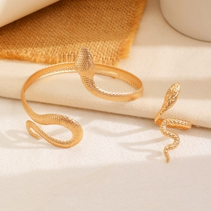 Golden snake jewelry set featuring a textured wrap bracelet and matching snake ring