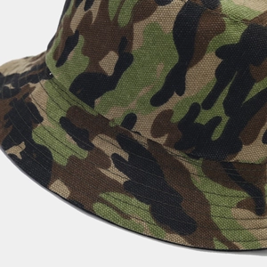 Detail of camouflage bucket hat showing canvas texture and reinforced stitching lines