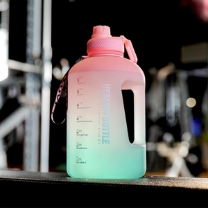 Detail of gradient sports water bottle featuring time markers and motivational phrases