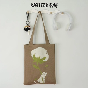 Detail of khaki knitted tote bag with cute cat and white flower pattern embroidery