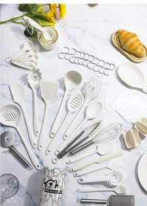 Detailed view of white marble pattern kitchenware set with silicone spatulas and storage bucket