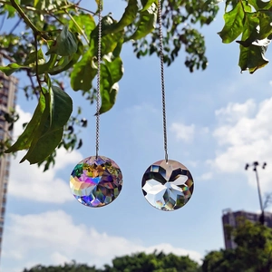 2pcs K9 crystal prism suncatchers with metal chains hanging on a branch against blue sky
