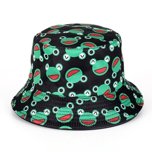 Detail of cotton bucket hat with funny green frog patterns and wide sunshade brim