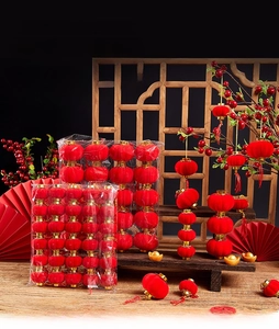 Detail of red flocked festive lanterns with gold trim and traditional Chinese decorations