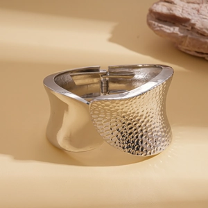 Detail of silver hinge bracelet featuring smooth mirror finish and hammered texture