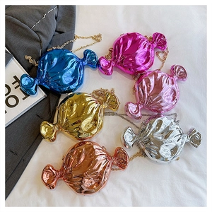 Flat lay of colorful candy-shaped clutch bags with metal chains in six shiny finishes