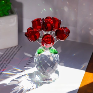 Macro shot of red crystal roses in a faceted clear glass vase with prism light effects