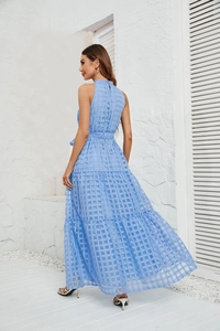 Detail of light blue tiered maxi dress featuring checkered textured fabric and waist belt