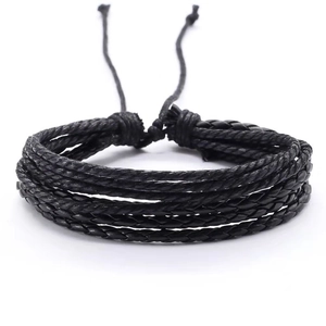 Detail of multi-layer black braided rope bracelet with adjustable drawstring closure