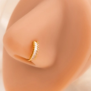 Close-up of golden leaf nose ring with rectangular cubic zirconia on a silicone model