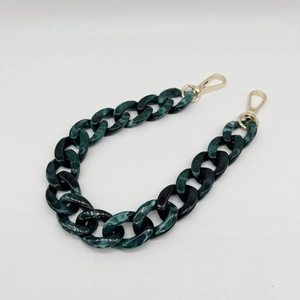 Close-up of dark green acrylic bag chain with marble pattern and gold lobster clasps
