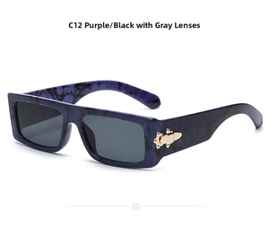Close-up of purple marble rectangle sunglasses with vintage gold metal hinge accents