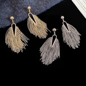 French vintage tassel drop earrings in gold and silver finish on black velvet display